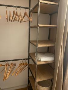 a walk in closet with woodenadders and hangers at Petite maison cocooning classée 3 étoiles à Bormes les mimosas in Bormes-les-Mimosas