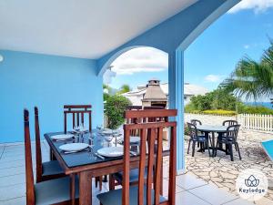 a dining room with a table and chairs on a patio at Villa Aldabra - 3 etoiles avec piscine à Saint-Leu in Saint-Leu