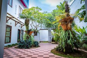 une cour d'un bâtiment avec des arbres et des plantes dans l'établissement Family Hotel Gradia 2, à Batu