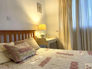 a bedroom with a bed and a table with a lamp at ZenBerry house in Mandria