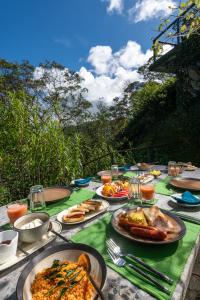 a table with many plates of food on it at The Cavern in Agrapatana