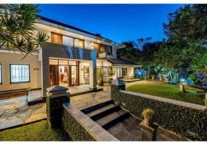 a house with a staircase leading to the front yard at Sheppard Boutique Hotel in Nelspruit