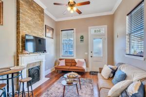 a living room with a couch and a fireplace at Spacious Centrally Located Home in New Orleans
