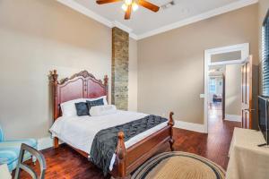 a bedroom with a large bed and a ceiling fan at Spacious Centrally Located Home in New Orleans