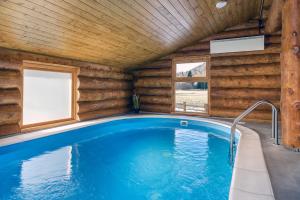 - une piscine dans une cabane en rondins dotée d'une fenêtre dans l'établissement Loghouse Madeira, Fužine., à Fužine