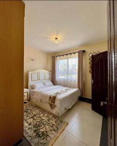 een slaapkamer met een groot bed en een raam bij PARADISE PALACE in Nairobi