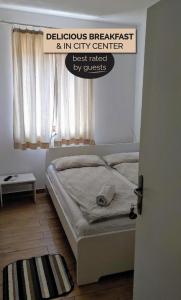 a bed in a bedroom with a sign on the door at B&B Isola in Izola