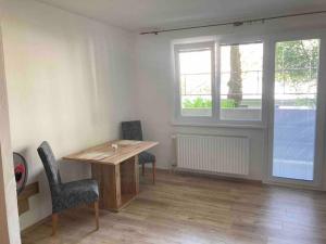 een kamer met een houten tafel en 2 stoelen bij Dubravka in Bratislava