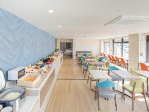 a restaurant with tables and chairs and a buffet at Tabino Hotel EXpress Narita in Narita