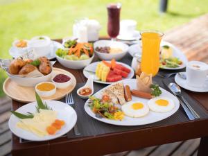 a table with plates of breakfast food on it at Ibis Bangkok Riverside in Bangkok +36 photos