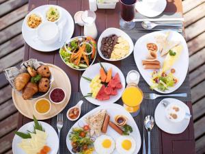 a table with many plates of food on it at Ibis Bangkok Riverside in Bangkok