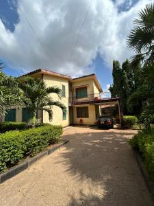 a house with a car parked in a driveway at Mopearlz 4bedroom villa Nyali in Mombasa