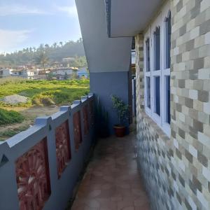 a balcony of a house with a view of the ocean at Coorg Mists in Madikeri
