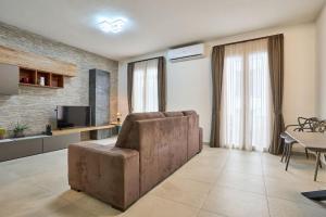 a living room with a couch and a table at 2 Bedroom Apartment St. Julians in St Julian's