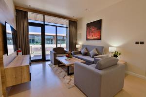 a living room with two couches and a table at Cloud 7 Residence AlUla in AlUla