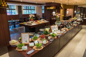 a buffet line with food on display in a restaurant at Hotel Ryutouen in Saga