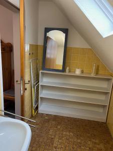 a bathroom with a sink and a mirror at Ferienwohnung Alte Schule in Winterberg +12 photos