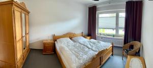 a bedroom with a large bed and a window at Ferienwohnung Alte Schule in Winterberg