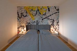 a bedroom with a bed and a wall with graffiti at Casa Lorsch 1 in Lorsch