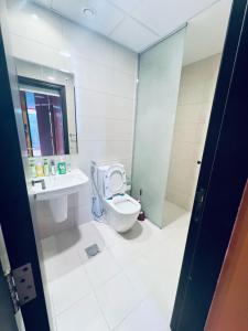 a bathroom with a toilet and a sink at Moon Backpackers Burjman Exit 2, Family Partitions, Loft partitions, in Dubai