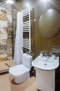 a bathroom with a toilet and a sink and a mirror at HB apartments Mitskevichi in Tbilisi City