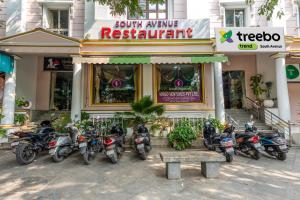 a group of motorcycles parked in front of a restaurant at Treebo Trend South Avenue 4 Min Walk From Promenade Beach in Pondicherry
