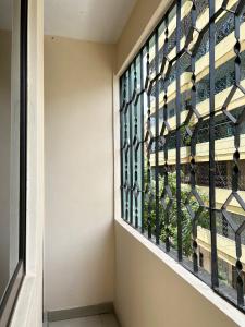 a window in a hallway with a view of a building at Karibu house in Dar es Salaam