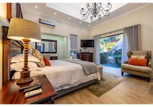 a bedroom with a bed and a table with a lamp at Sheppard Boutique Hotel in Nelspruit