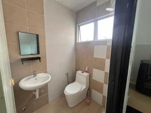a bathroom with a toilet and a sink at MamaShy Homestay Manjung -FREE WIFI- in Seri Manjung +3 photos