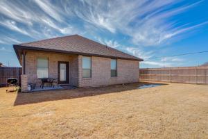 a small brick house with a fence in a yard at Entire House~ Spacious~ Prime Location~ Backyard in Lubbock