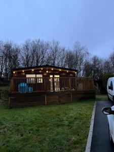 a house with lights on it in the grass at 2 bedroom lodge - The Cherries (24) Caer beris holiday park in Builth Wells