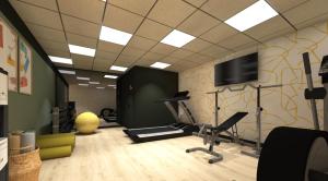 a room with a gym with a treadmill and a tv at Sure Hotel by Best Western Caen Memorial in Caen