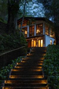 a staircase leading up to a house at night at The Weir House in Ulapane
