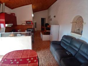 a living room with a couch and a kitchen at Bela Vista House - Quinta amoreira in Benafim