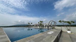 - une vue sur la piscine avec un ciel bleu dans l'établissement Front One Hotel Gombong, à Gombong