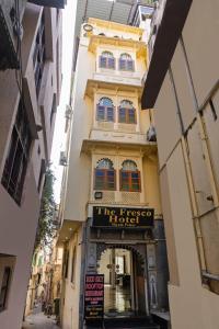 a building with a sign that reads the first hotel at Treebo Trend The Fresco Lake Pichola in Udaipur
