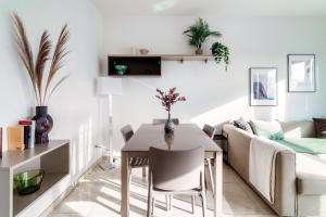 a living room with a table and a couch at Il Parco 13 by Quokka 360 - strategic flat in Lugano centre in Lugano