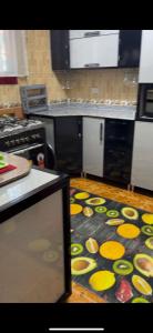 a kitchen with a counter top with yellow circles on the floor at القاهرة مدينة نصر in Cairo