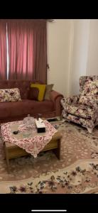 a living room with a couch and a coffee table at القاهرة مدينة نصر in Cairo