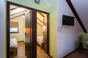 a room with a sliding door with a tv on a wall at Zagorska Klet in Gorjakovo