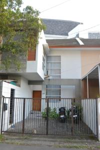 a house with a fence in front of it at Bracha house in Legian