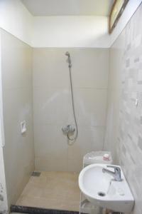 a bathroom with a shower and a sink at Bracha house in Legian +4 photos