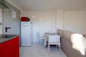 eine kleine Küche mit einem Tisch und einem weißen Kühlschrank in der Unterkunft Apto. BLAIA in Irún