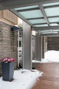 a covered area with snow on the ground and a building at Luxorius apartment on the beach and the citycenter in Helsinki
