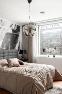 a bedroom with a large bed and a window at Luxorius apartment on the beach and the citycenter in Helsinki
