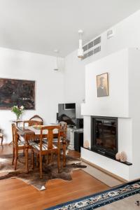 a dining room with a table and a fireplace at Luxorius apartment on the beach and the citycenter in Helsinki