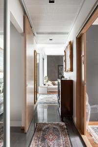 a hallway with a living room with a rug at Luxorius apartment on the beach and the citycenter in Helsinki