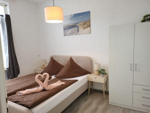 a bedroom with a bed with a pink flamingo on it at Haus Deitje in Borkum