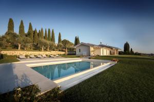 a swimming pool in the yard of a house at Villa F in Bardolino