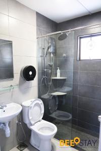 a bathroom with a shower and a toilet and a sink at Melaka Afamosa DAmour Villa 12PAX with Private Pool & BBQ in Kampong Alor Gajah